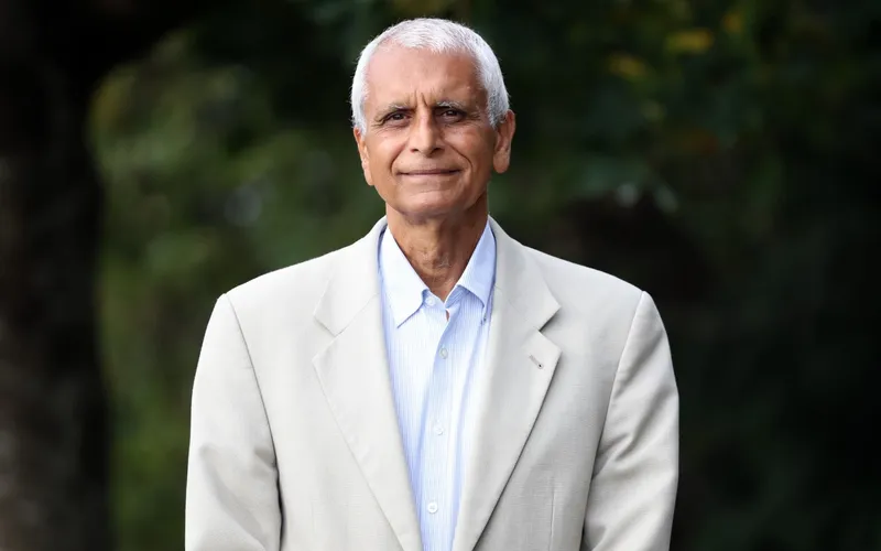 Asif Hasan, in a pale jacket, photographed outdoors.