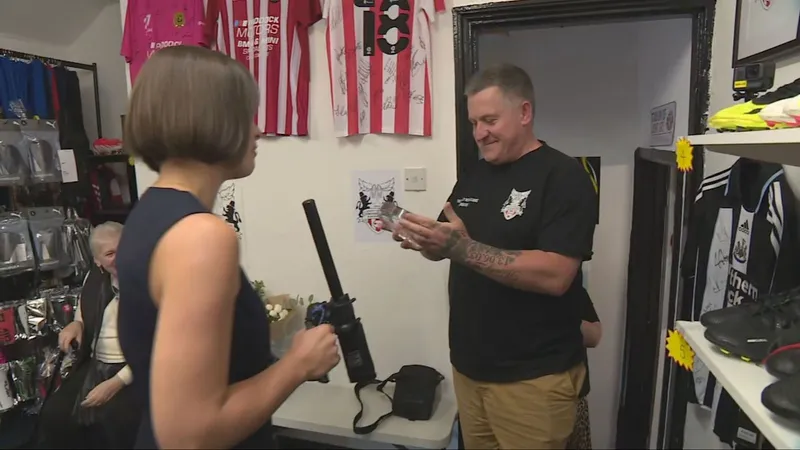 ITV Tyne Tees presenter Amy Lea surprises Michael McWilliams with his award, in a room hung with football shirts.